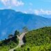Tinchuley, a serene eco-village in West Bengal, offers panoramic Himalayan views, orange orchards, tea gardens, and peaceful homestays.